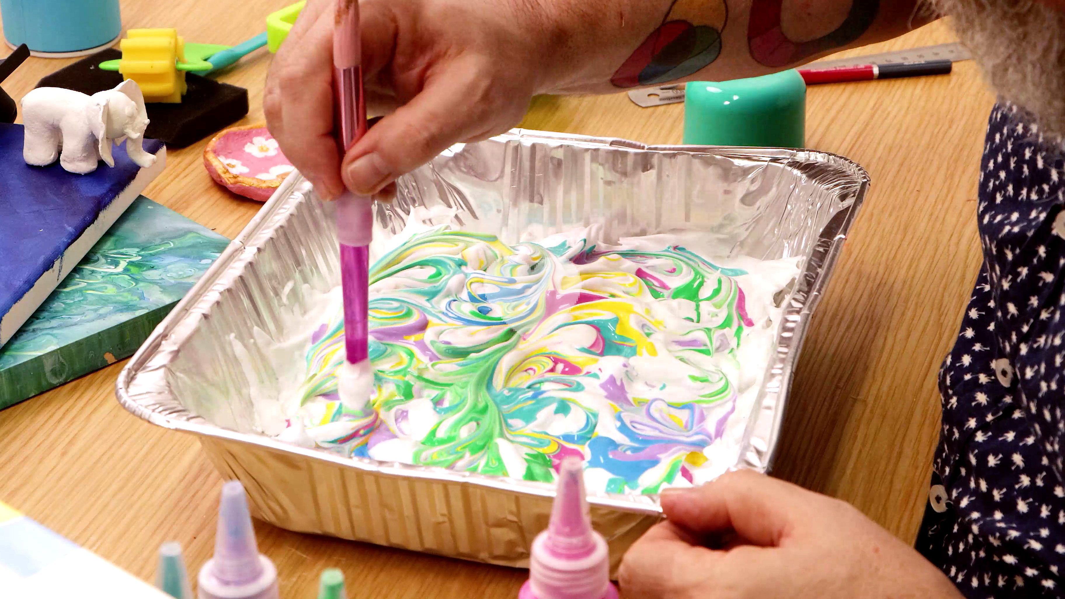 toddler experimenting with sensory painting