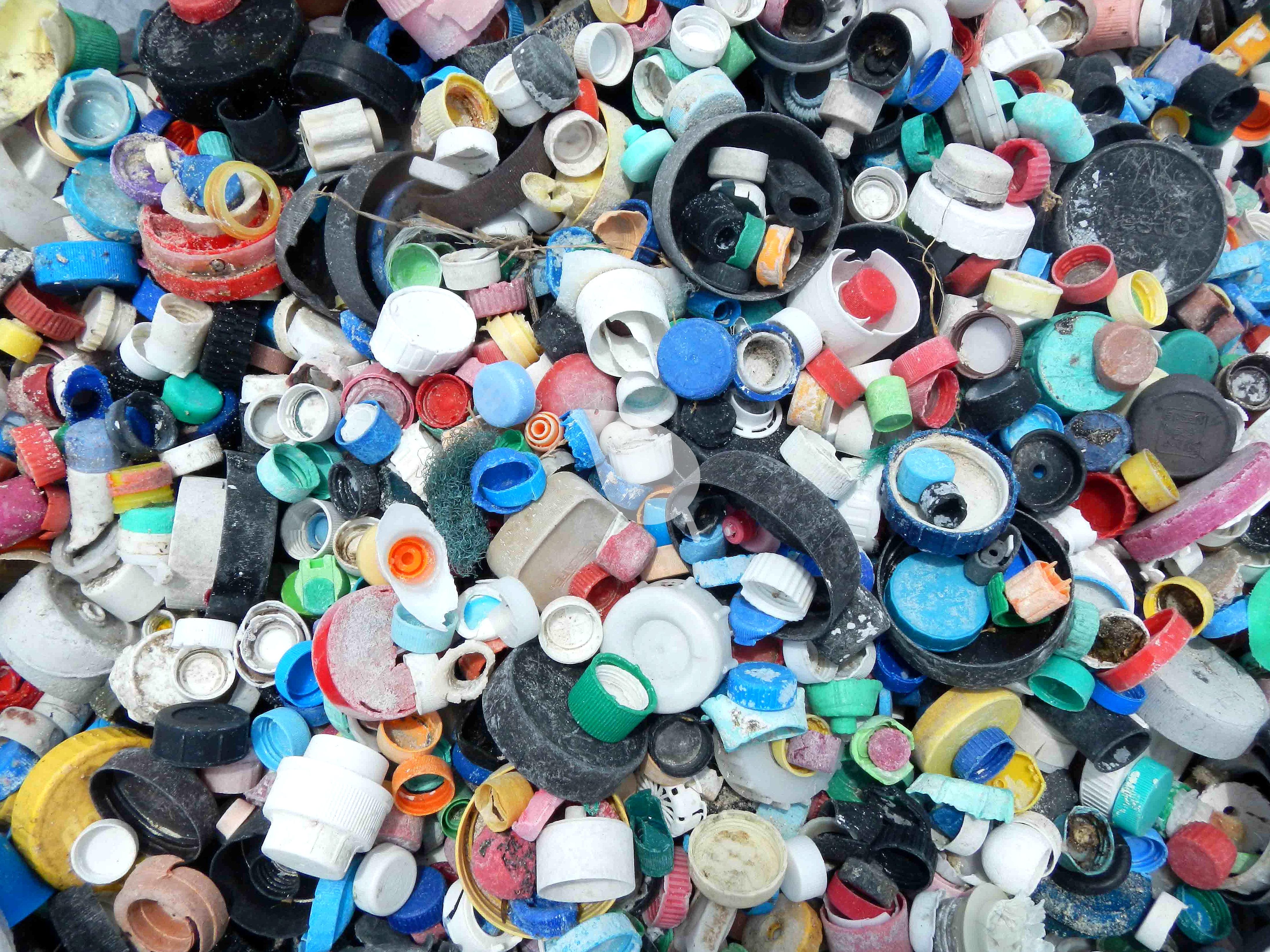 Bottle caps polluting ocean and beach
