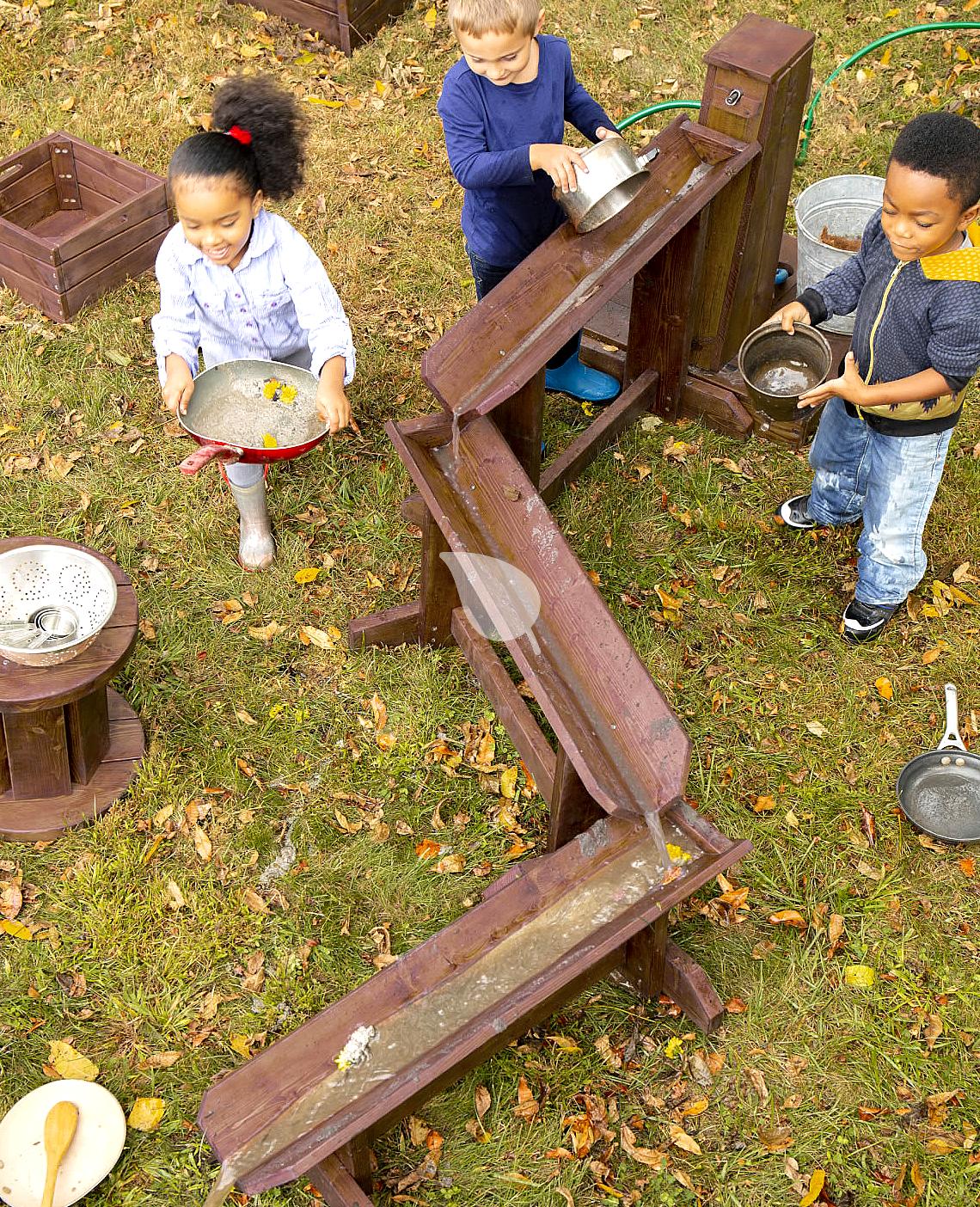 Toddler playing with plants on balcony