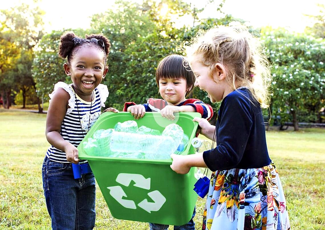 Happy kids doing fun recycling activities outdoors