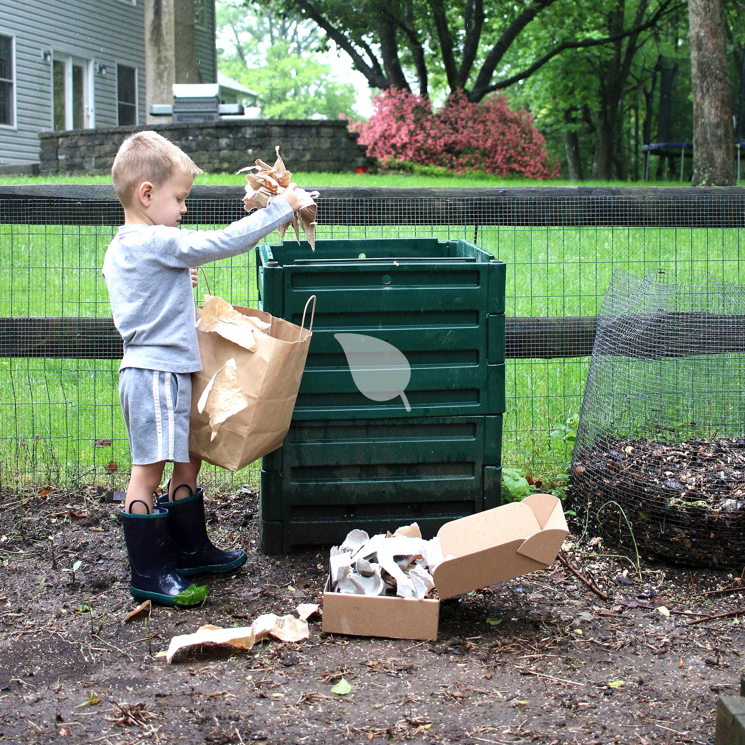 Child adding scraps to home compost bin
