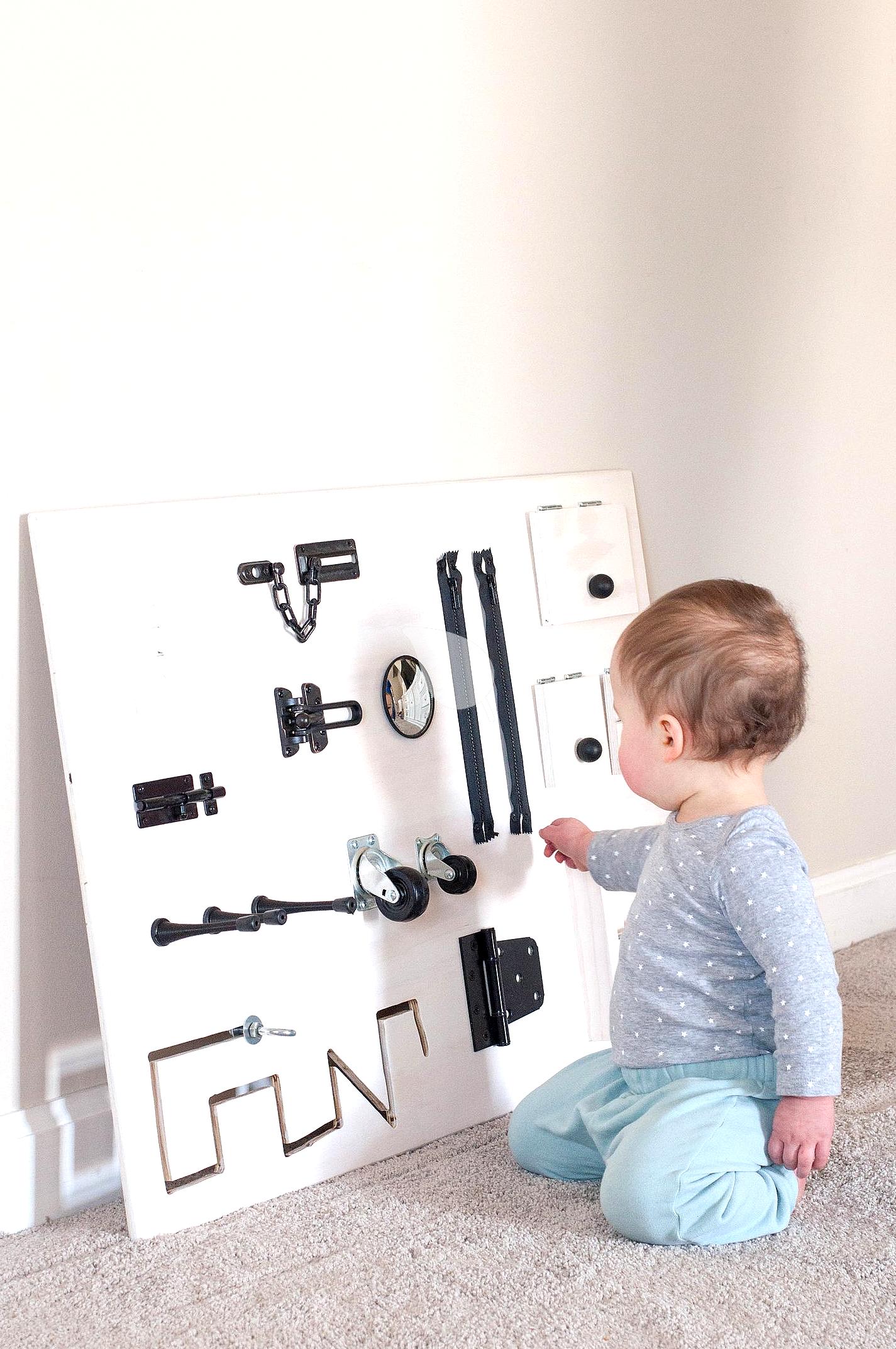DIY toddler busy board with latches and knobs
