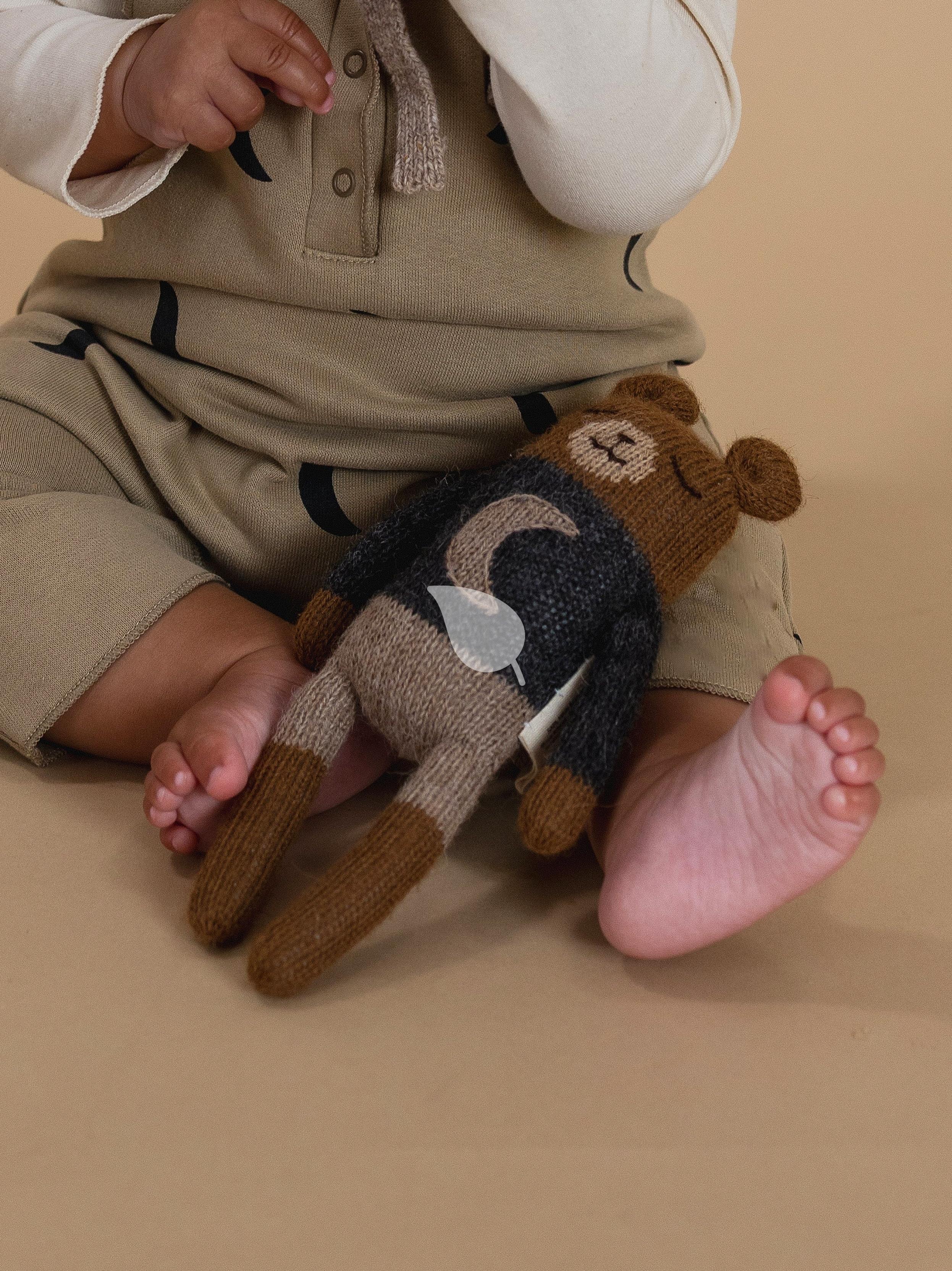 Toddler happily playing with safe organic toys